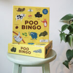 Poo Bingo on a green stool with a green plant to the right